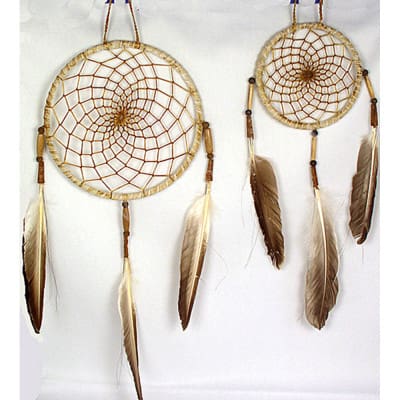 Two Navajo Dream Catchers feature web-like patterns, tan beads, and brown and white feathers, all handcrafted with sinew, feathers and glass beads.