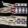 The Clay Wampum Bracelets features woven beaded strips with white and purple wampum beads, red or white crow beads, and several white leather fringe strands on one end.