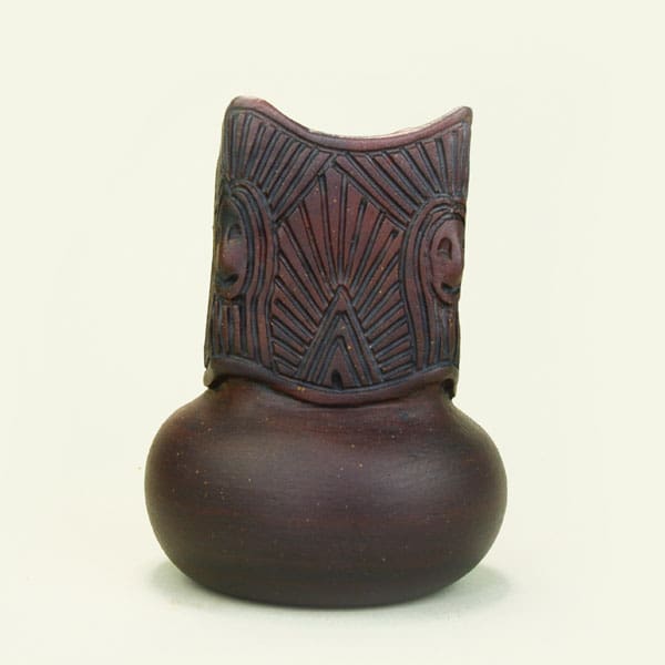 Brown vase with faces signed Deyo-nu-nyak-ojis-doh. 2