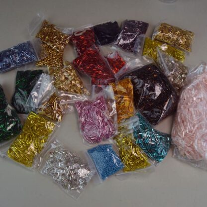 This 34 ounces of assorted Bugle Beads comes in assorted Colors and Sizes. These beads are also great for making simple bracelets. One of a Kind.