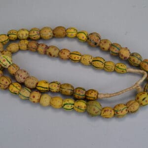 Antique Venetian Trade Beads - Fiber Strands of Venetian Mustard trade beads with green lines and red dots designs on a strand. Limited Quantities.