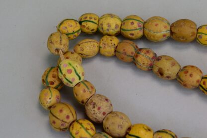 Antique Venetian Trade Beads - Fiber Strands of Venetian Mustard trade beads with green lines and red dots designs on a strand. Limited Quantities.