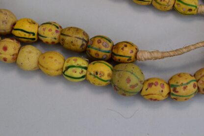 Antique Venetian Trade Beads - Fiber Strands of Venetian Mustard trade beads with green lines and red dots designs on a strand. Limited Quantities.