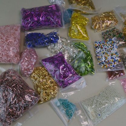 This Bugle Bead 33 Ounce package. They are of Different Sizes and Colors. This lot has a seed bead surprise . Great Addition to your project. One of a Kind