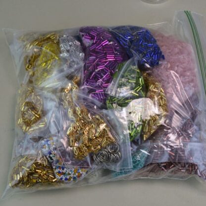 This Bugle Bead 33 Ounce package. They are of Different Sizes and Colors. This lot has a seed bead surprise . Great Addition to your project. One of a Kind