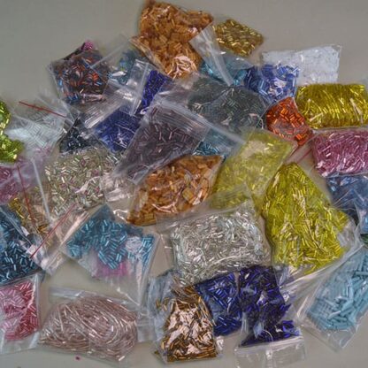 his Bugle Bead Group Lot comes in a 27ounce package. They are of Different Sizes and Colors. Great Addition to your project. One of a Kind