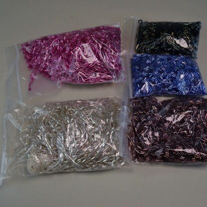 This Bugle Bead Iridescent Lot comes in a 29ounce package. They are of Different Sizes and Colors. Great Addition to your project. One of a Kind