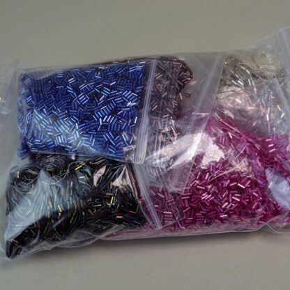 This Bugle Bead Iridescent Lot comes in a 29ounce package. They are of Different Sizes and Colors. Great Addition to your project. One of a Kind