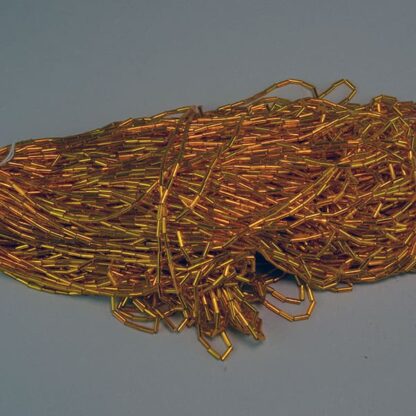 These Gold Silver Lined Bugle Beads are approximately 7mm x 2 mm and come in a 14 oz package. Crafters often use them for creating beaded fringe. One of a Kind!