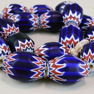 Large Glass Chevron Beads , are blue, white and rd. they are oblong. these beads come on a string.