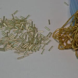 This Silver and Gold lot of Bugle Beads come in a 27 ounce package.