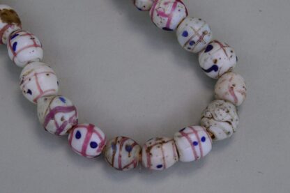 These Venetian Trade Beads are on a Fiber Strands with white trade beads with pink lines and Blue dots. . Limited Quantities.