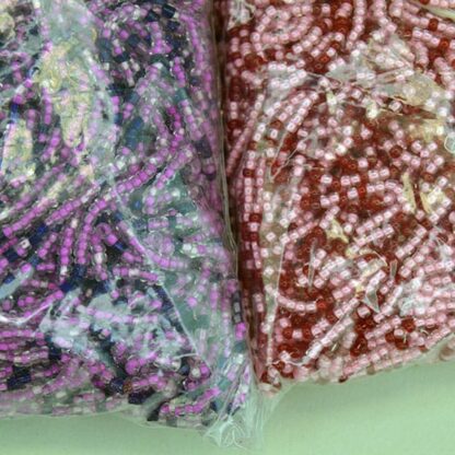 11/0 Seed Bead comes in a 16 ounce package. Colors are lined pink, light pink, fuchsia, trans red and royal blue in a tubular shape. On of a Kind.