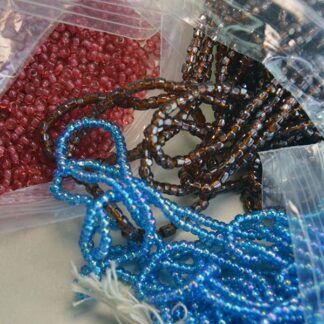 These 9/0 Seed Bead Lot are a must have! They come in a 9 ounce bag with Cuts Iris light Blue, and Brown , Also a 10/0 raspberry