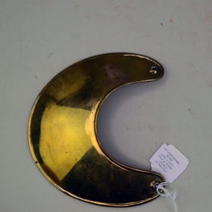 This Gorget Cast Brass Plated.  This Gorget has drilled holes. This piece measures about 5 inches across at the widest point. On of a Kind.