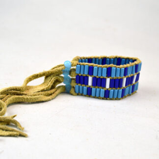 Bracelet Three Row Wampum features Glass Wampum Beads in White , light Blue, and Royal Blue. three Glass light blue Crow Bead closures. Limited quantities.