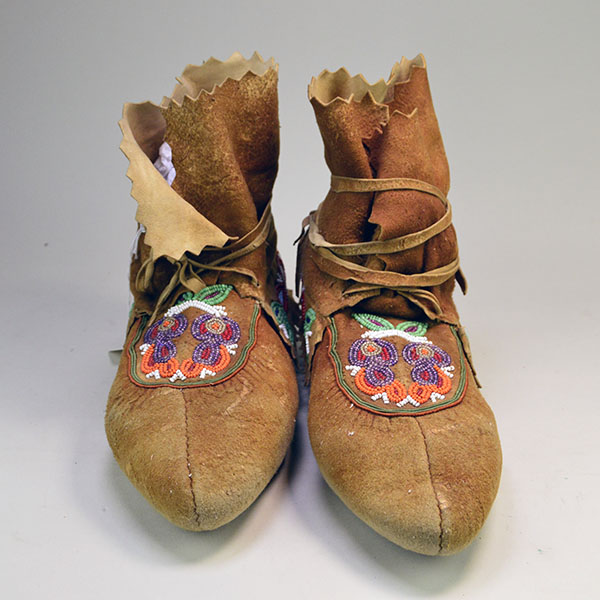 These Moosehide Cree-Style Moccasins feature a soft sole and vibrant floral beadwork pattern, all beautifully crafted from brain-tanned moosehide leather.