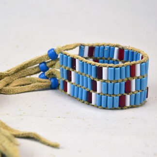 Wampum Three Row Bracelet features Glass Wampum Beads in White , light Blue, and Trans Red with blue Crow Bead closures. Limited quantities.