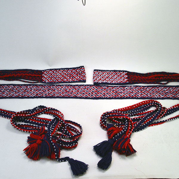 This Seminole-style garter and belt set showcases vibrant craftsmanship, finger-woven from rich red and navy blue yarn. One of a Kind.