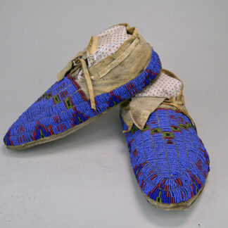 These antique moccasins, crafted in the fully beaded Northern Plains style, are ready to enhance any collection. 10" long by 4" wide. one of a kind