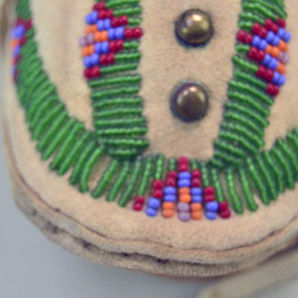 Pictured here is the beadwork on these Northern Plains-style child’s moccasins, where vibrant patterns are stitched into supple deerskin.