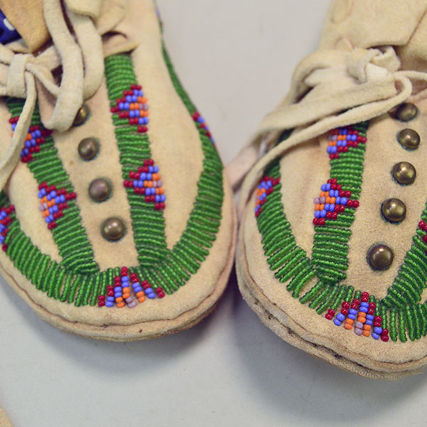 Pictured here is the beadwork on these Northern Plains-style child’s moccasins, where vibrant patterns are stitched into supple deerskin.