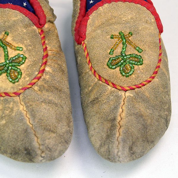 Pictured here are vintage child’s moccasins in Cree style, featuring center seam construction and a beautifully beaded floral design on the vamp