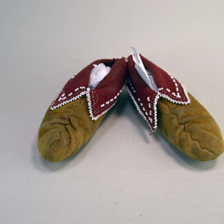 These Eastern Woodland style moccasins showcase soft leather construction with a traditional center seam. fully lined with red wool. One of a Kind.
