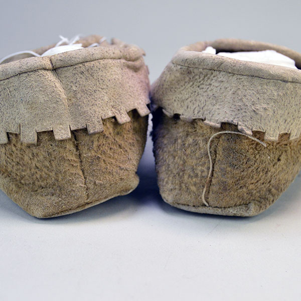 Pictured here is the back view of moccasins crafted from brain-tanned deer hide.