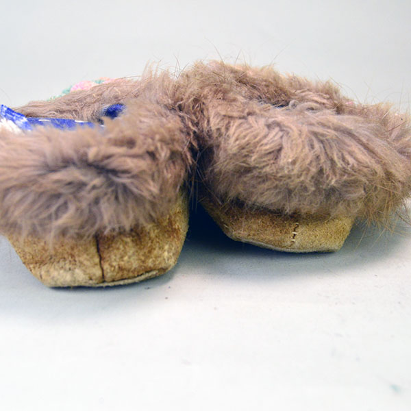 The fur accents on the cuffs in this picture add warmth, texture, and a touch of traditional elegance to the moccasins.