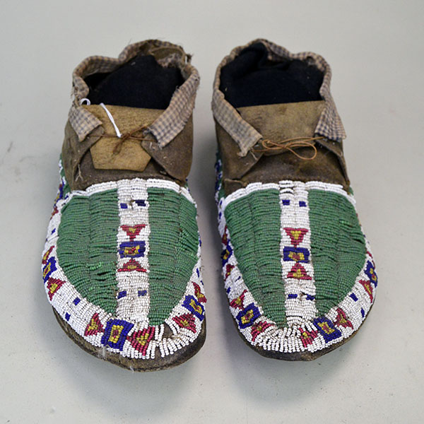 Antique Northern Plaine fully beaded moccasins with fabric cuff top view.