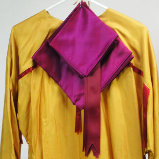 This Ribbon Shirt- Gold Silk features Burgundy ribbon trim on the front, sleeves and back. lying flat Width: 24″Length: 30″Sleeve Length: 24″ One of a Kind