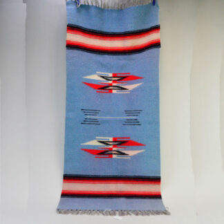 This handwoven wool rug in Mexican Chimayo style features traditional pattern. Measuring 39" long by 17.5" wide. One of a Kind.