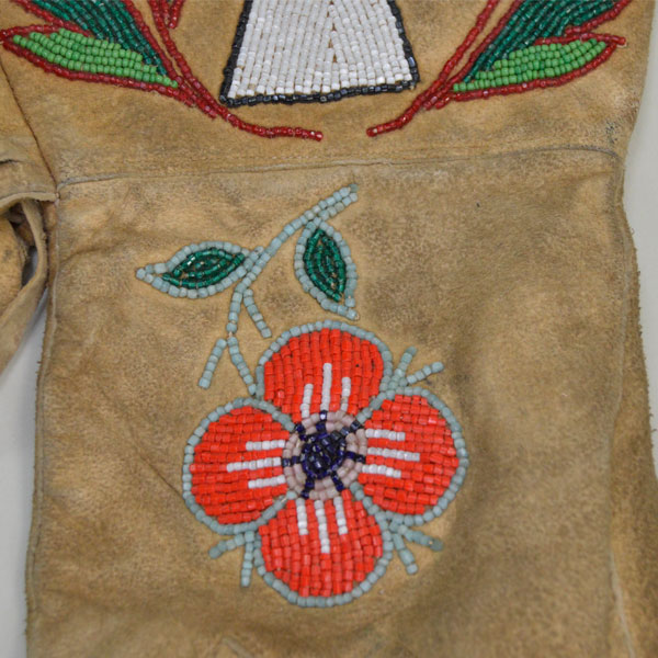 Beaded leather gauntlets with a floral and deer motif close up of flower.