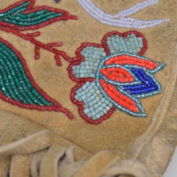 Beaded leather gauntlets with a floral and deer motif flower view.