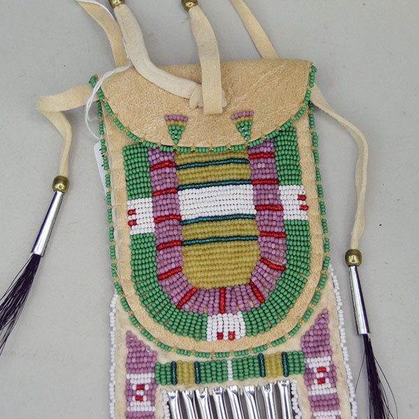 Close up front view of a green Arapaho style strike a lite bag.
