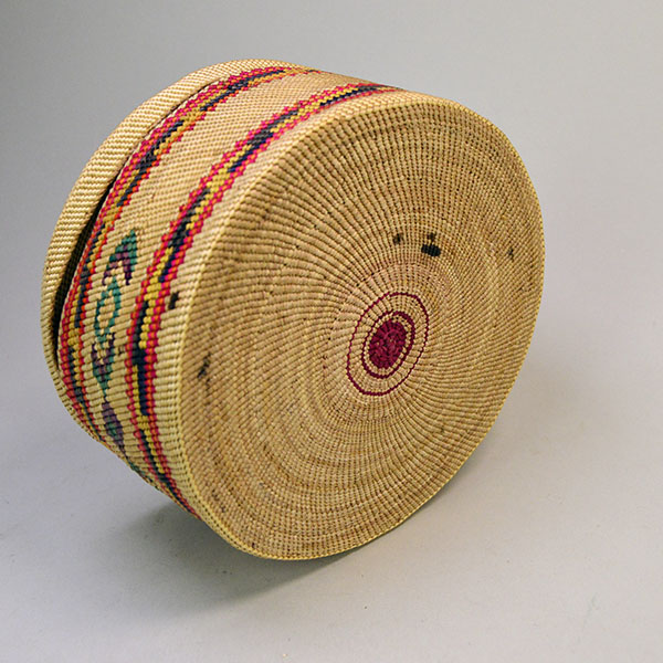 Pictured here is the bottom of the large antique Nootka-style basket, showcasing its finely twined base and expert craftsmanship