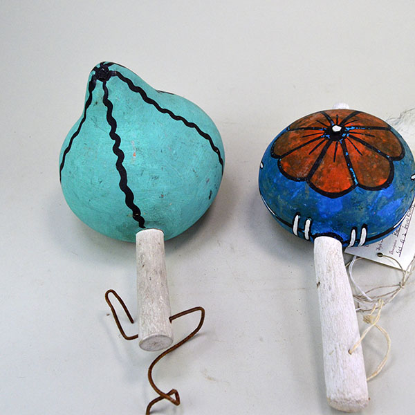 Pictured here is the reverse side of the Hopi-style rattles, featuring a vibrant flower motif and a watermelon face—each element reflecting playful artistry and cultural expression.