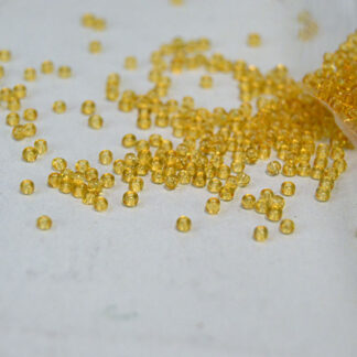 Elevate your beadwork with these Seed Beads- Tran Amber 12/0. Made in CZECHOSLOVAKIA and packaged in a generous 1/2 kilo lot.