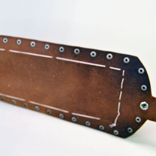 this vintage handcrafted belt—beaded in a feather design. pictured is the inside showing the rich saddle leather.