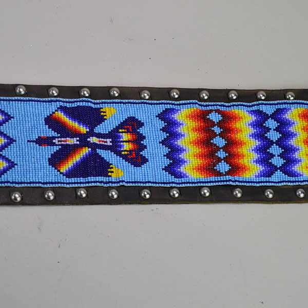Pictured here is the vintage handcrafted belt—beaded with water birds, geometric patterns, and accented by .25-inch silver spots.
