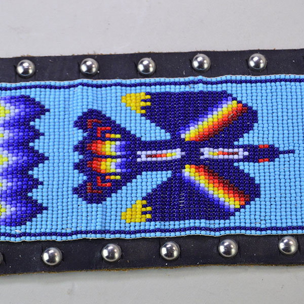 Pictured here is the vintage handcrafted belt—beaded with water birds, geometric patterns, and accented by .25-inch silver spots.