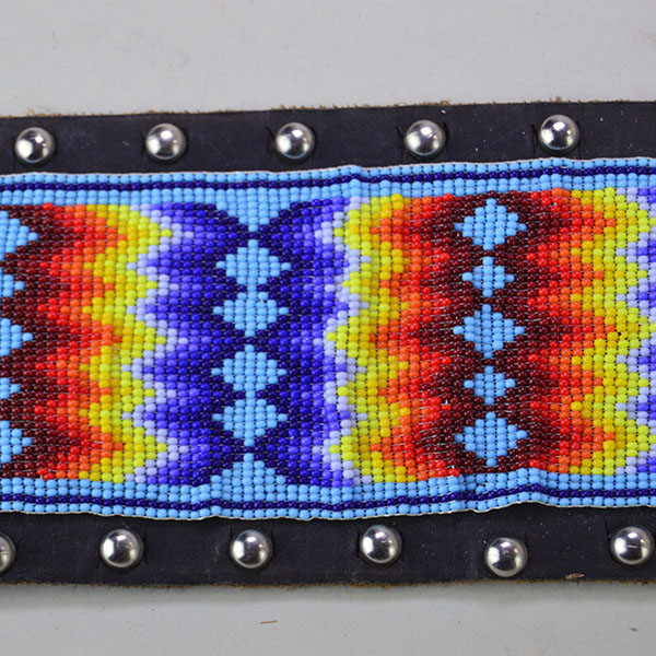 Pictured here is the vintage handcrafted belt—beaded with water birds, geometric patterns, and accented by .25-inch silver spots.