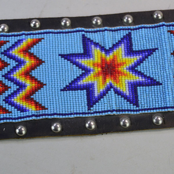 Pictured here is the vintage handcrafted belt—beaded with water birds, geometric patterns, and accented by .25-inch silver spots.