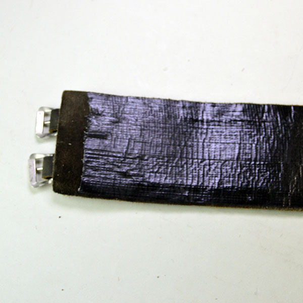 This vintage handcrafted beaded Water Birds belt, pictured here, shows black tape on the inside and features two leather strips with holes on one side and two smaller strips on the other, fitted with silver buckles for closure