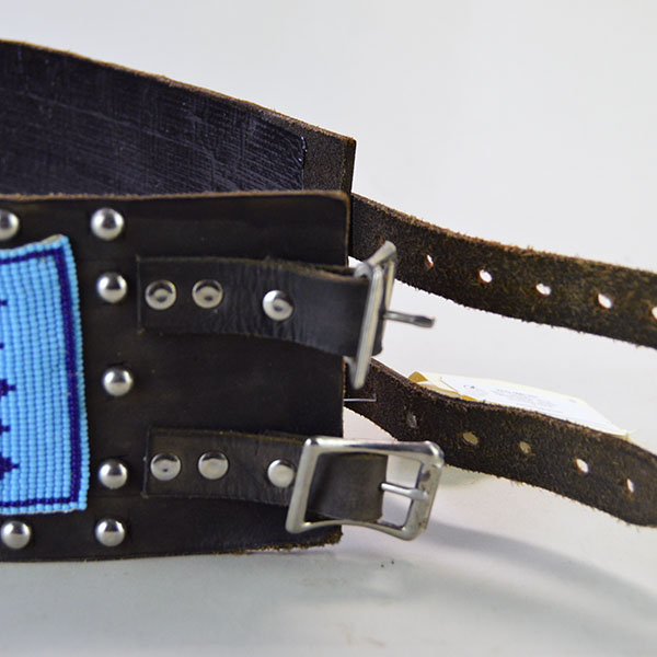 This vintage handcrafted beaded Water Birds belt, pictured here, shows black tape on the inside and features two leather strips with holes on one side and two smaller strips on the other, fitted with silver buckles for closure