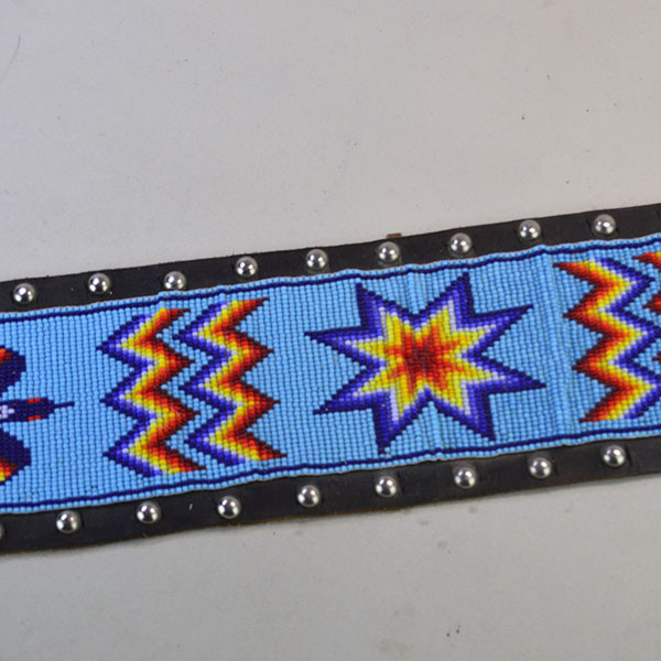 Pictured here is the vintage handcrafted belt—beaded with water birds, geometric patterns, and accented by .25-inch silver spots.
