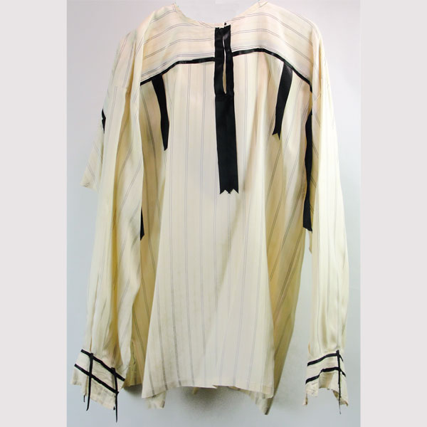 This Ribbon Shirt- Ivory & Black features Black silk ribbon trim. This picture if show casing the back of the ribbon shirt.