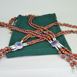 Elevate your dance regalia with this eye‑catching light red Bandolier- Mescal Beads set. Each piece measures a full 37" long. One of a Kind.