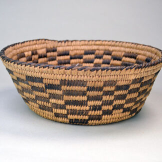 This beautiful handwoven Pima‑style basket features tightly coiled grass and yucca, with devil’s claw creating the dark designs. One of a Kind.